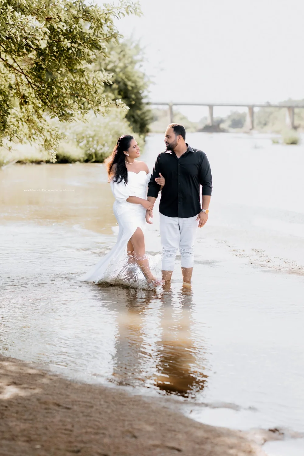 Couple walking by a river during a pre-wedding shoot